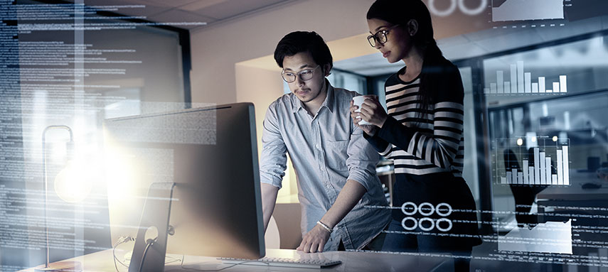 coworkers looking at a computer